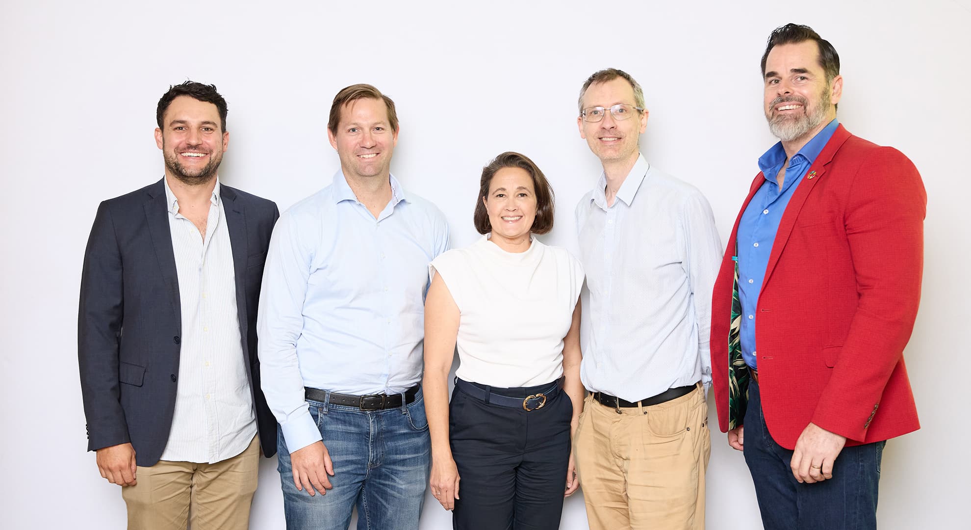 A group of five I-VADE researchers standing in a row in front of white backdrop.