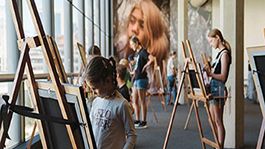 women painting on large canvases