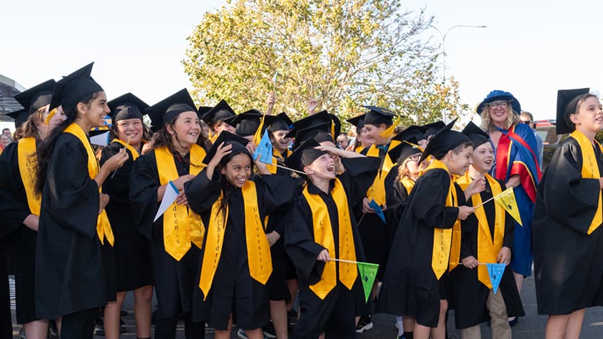 Children cheering in their regalia.