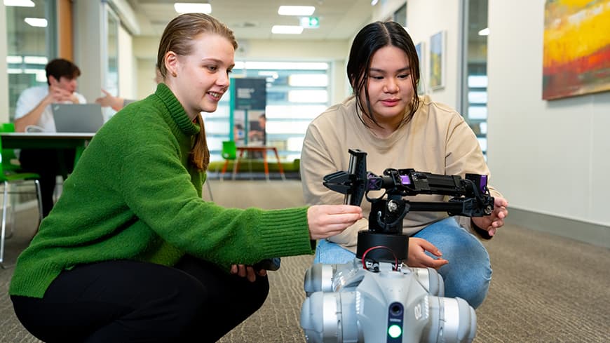 Two young students and a robot