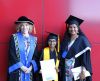 Deputy Vice-Chancellor Cobie Rudd, Sana Subramaniam, 9, and her mother Smitha Nair standing in their regalia, hats and gowns at the ECU South West graduation.