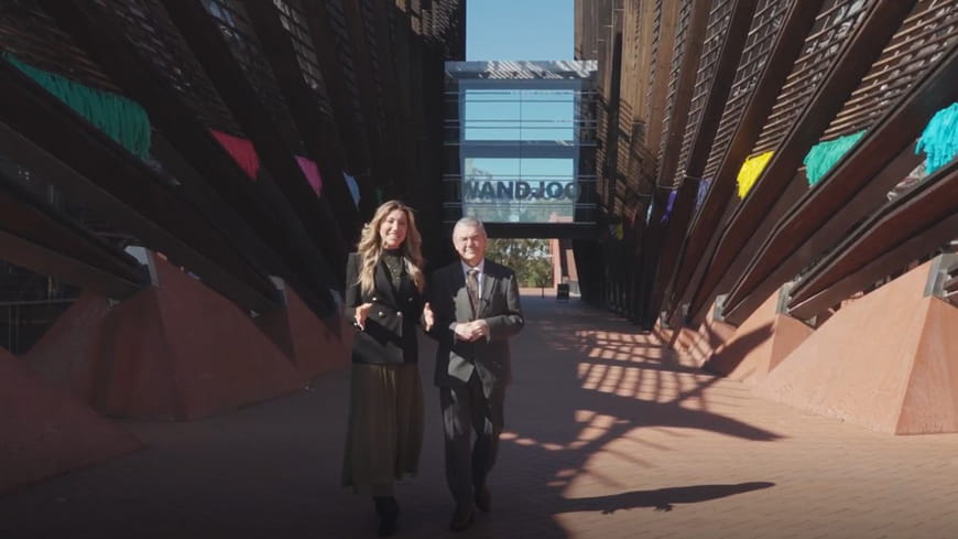 Business woman and man standing in front of entrance to Joondalup campus