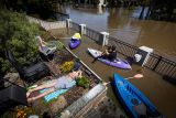 Photograph of a female sun baking amongst a flood situation.