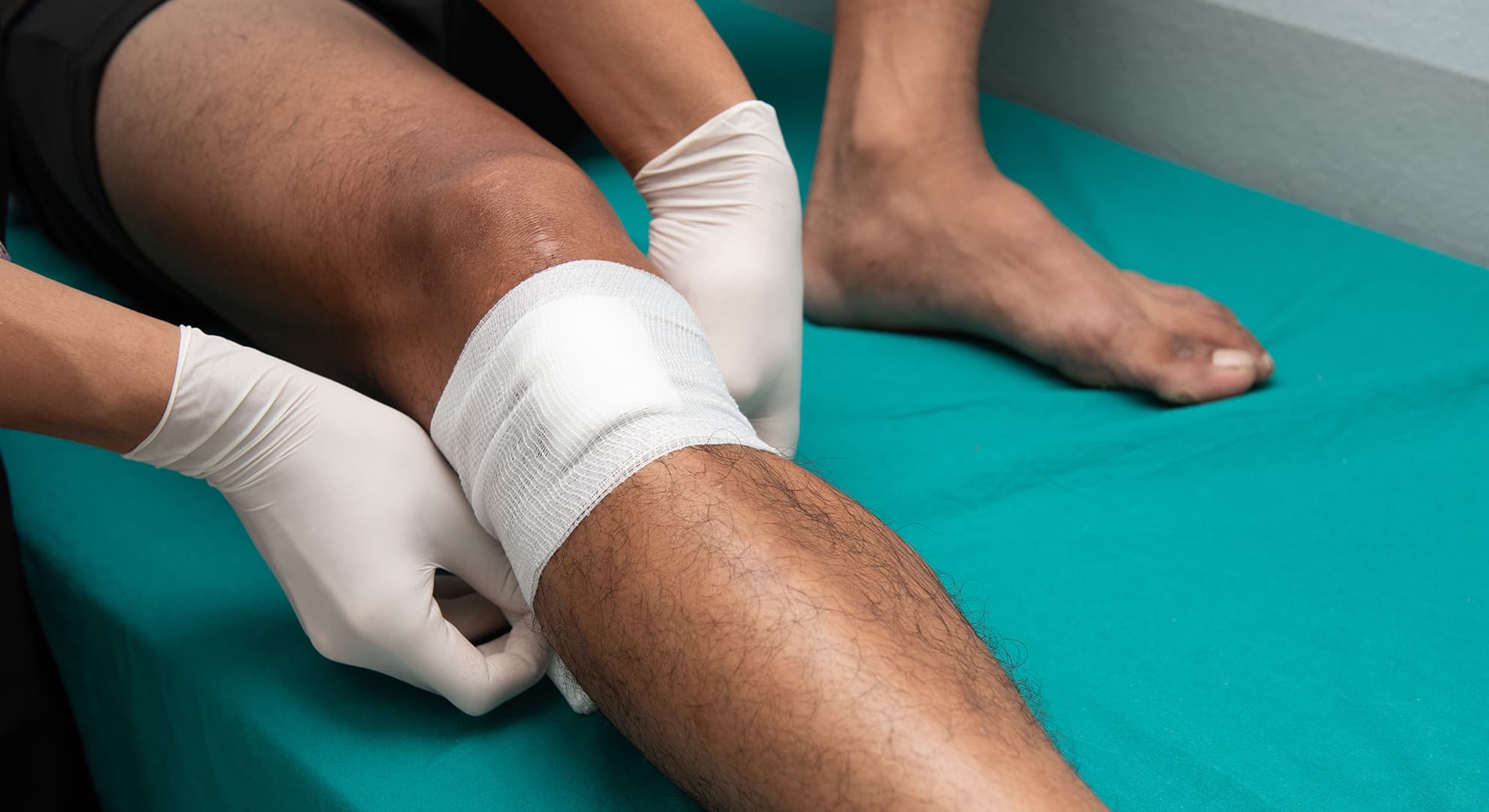 Man's leg getting wound treatment.