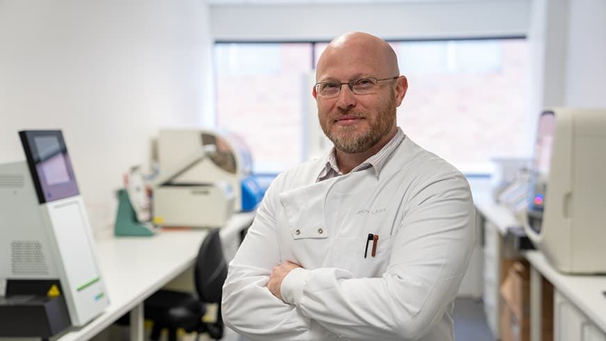 Professor Simon Laws standing in his laboratory.