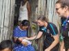 Student conducting a health check on a newborn infant